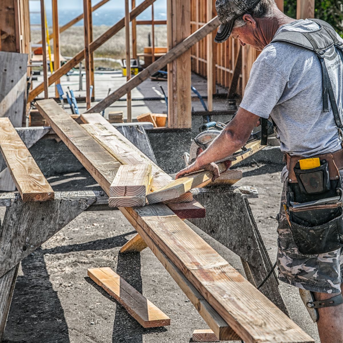 construction worker cutting lumber