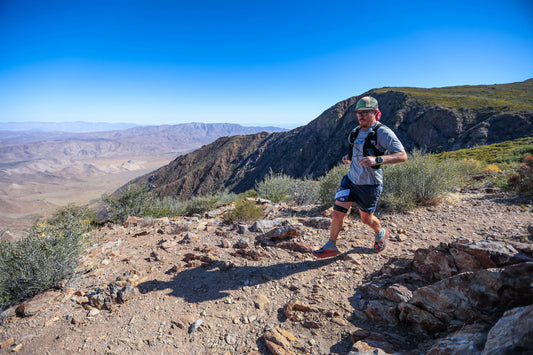 Beginners Guide to Start Running: Trail runner running with desert vista in the background
